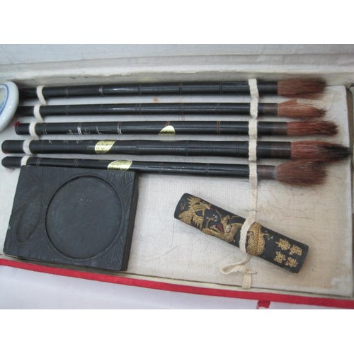 39 - A Chinese ink seal kit in a cloth clad box, and a Chinese brush painting kit in a case labelled Zhon... 