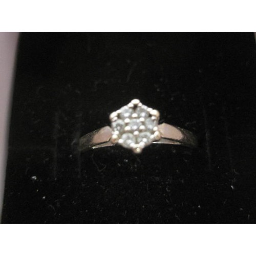35 - 18 carat white gold diamond ring - set with seven small diamonds in a round foliate setting, size P,... 