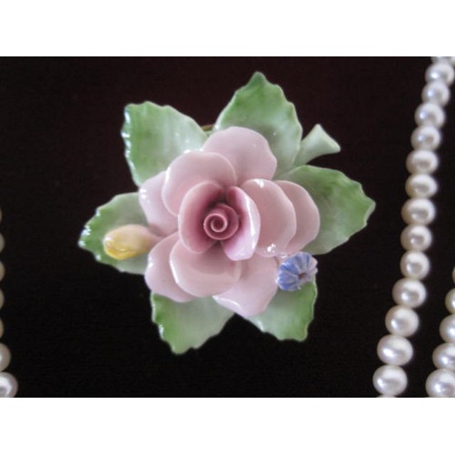 112 - A cased pearl necklace with a 9ct clasp and a boxed Royal Doulton rose