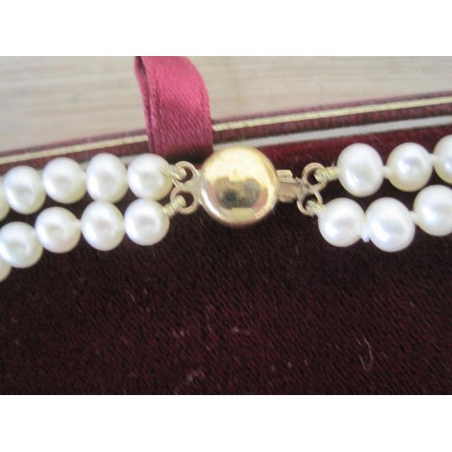 112 - A cased pearl necklace with a 9ct clasp and a boxed Royal Doulton rose