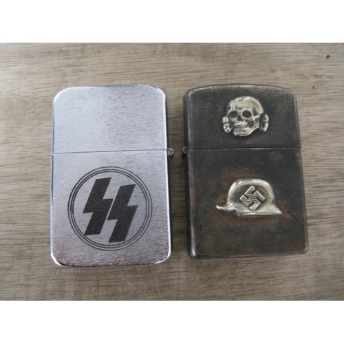 233 - A pair of metal ZIppo-style petrol lighters, one with the runes of the SS inscribed to one side, the... 