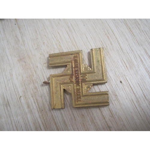 237 - A painted badge featuring a swastika: a swastika with ring mount marked 'fur treue dienste in der ss... 