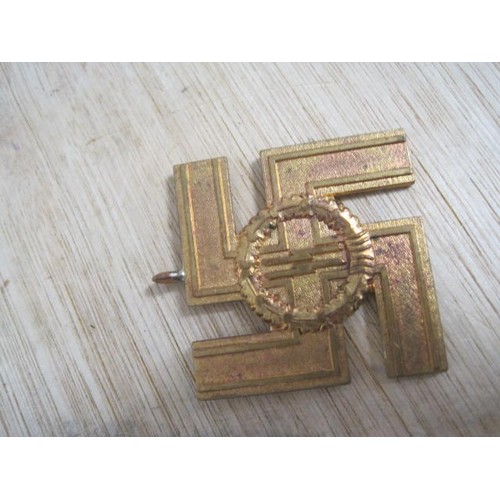 237 - A painted badge featuring a swastika: a swastika with ring mount marked 'fur treue dienste in der ss... 