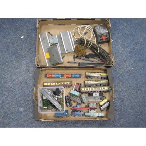 240 - Two trays containing an assortment of model railway items including track, engines, controller, buil... 