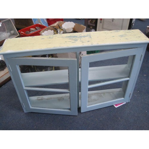 49 - A painted wall mounting cabinet of some age, the front doors glazed