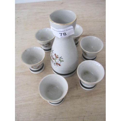 78 - Porcelain sake set comprising decanter and six cups, grey glaze with enamelled flower decoration