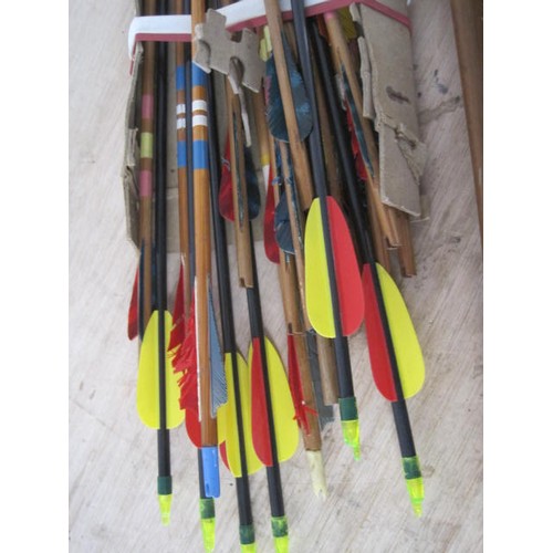 227 - A vintage wooden longbow in good order, and another, similar, smaller, plus an assortment of arrows ... 