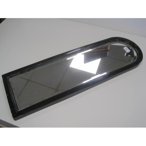 22 - Narrow arch-topped bevelled wall mirror in a wooden frame painted black. Height 74cm, width 24cm