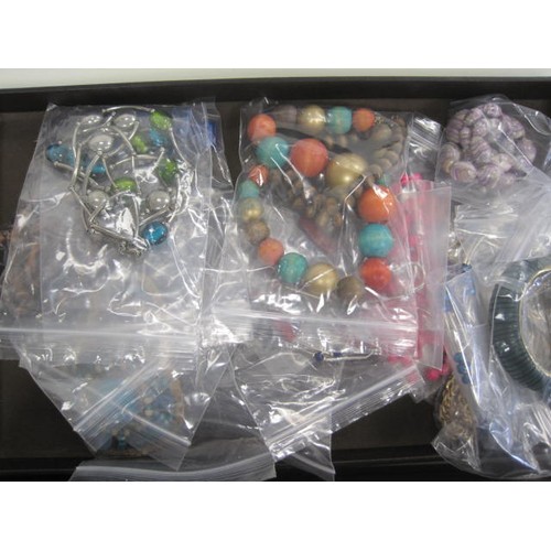 111 - Assorted costume jewellery, necklaces, bangles, pendants etc, contained in a dark brown leatherette ... 