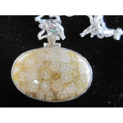 35 - 925 silver oval pendant set with a polished fossil style stone, pierced suspension loop, on a chain ... 