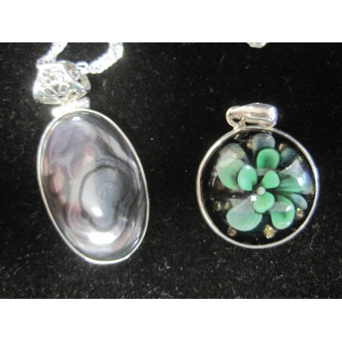 40 - 925 silver oval pendant set with a graphite-colour polished stone, pierced suspension loop, on a twi... 