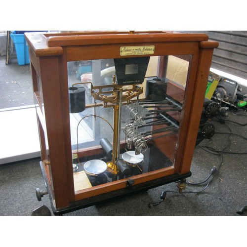 206 - A vintage Release-o-Matic scale with power unit, in glazed case and in good order