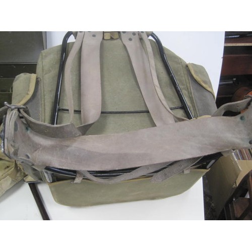 144 - A vintage framed military Bergan rucksack, a pair of military haversacks, a metal document container... 