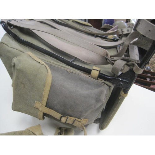 144 - A vintage framed military Bergan rucksack, a pair of military haversacks, a metal document container... 