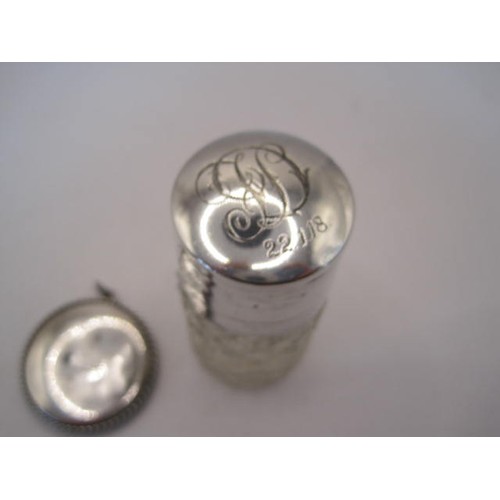 250 - Silver mounted dressing table bottle together with a pendant. Height of bottle 6.5cm, diameter about... 