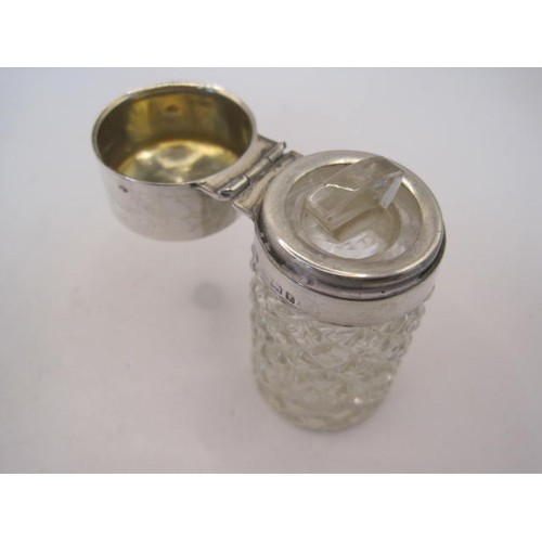 250 - Silver mounted dressing table bottle together with a pendant. Height of bottle 6.5cm, diameter about... 