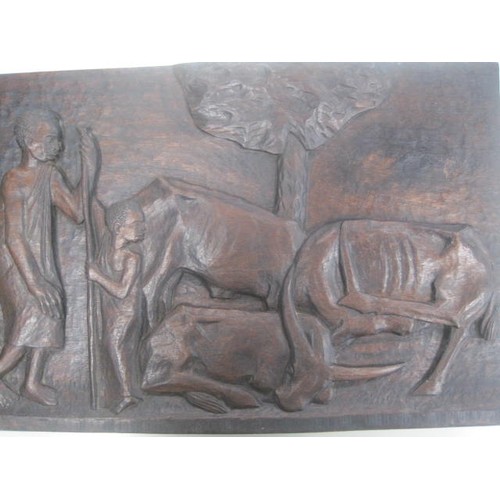 128 - An African hardwood relief carving of people, animals and trees by Munorgo Gehard, in good order