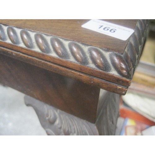 166 - A Games table with folding top lined with green baize sat upon sweeping claw legs