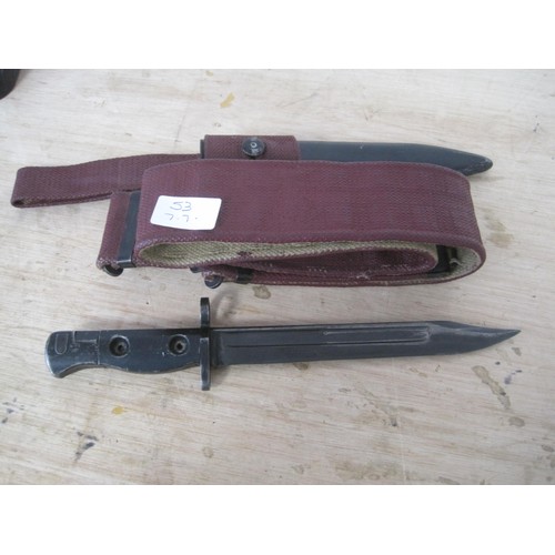 53 - A British Army SLR bayonet in scabbard with webbing frog and webbing belt, the whole in good order