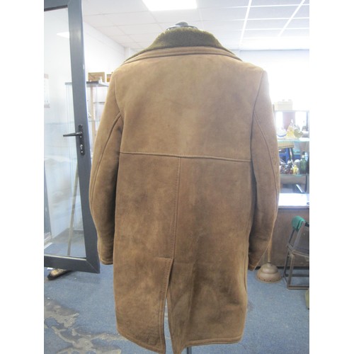 115 - Gents pale brown sheepskin coat. Double-breasted, three buttonhole. A/f spots of particular grubbine... 