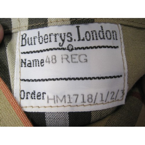 84 - Burberrys rain coat and Burberrys trench coat. The single-breasted rain coat is labelled 48 REG HM17... 