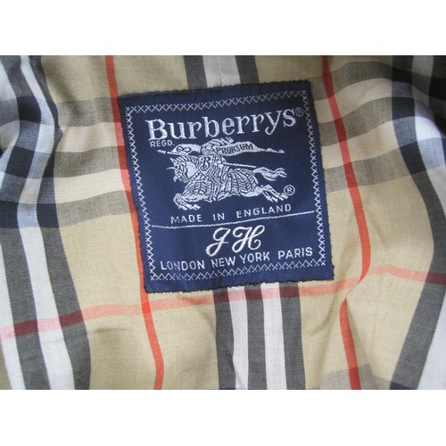 84 - Burberrys rain coat and Burberrys trench coat. The single-breasted rain coat is labelled 48 REG HM17... 