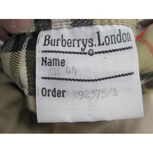 84 - Burberrys rain coat and Burberrys trench coat. The single-breasted rain coat is labelled 48 REG HM17... 