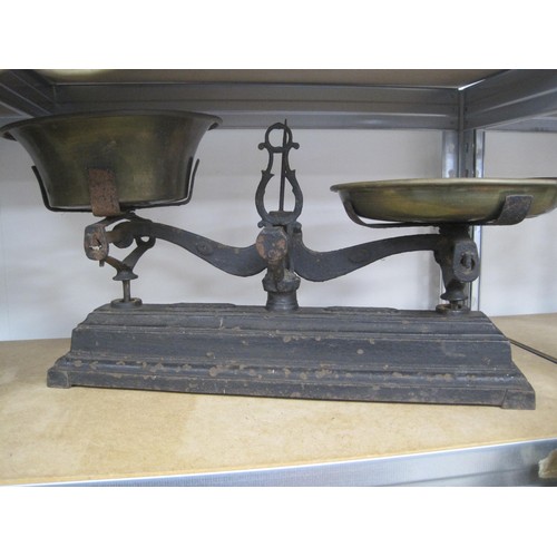 66 - Two sets of antique scales - (1) French cast iron shop balance marked Force 10kg with two brass tray... 