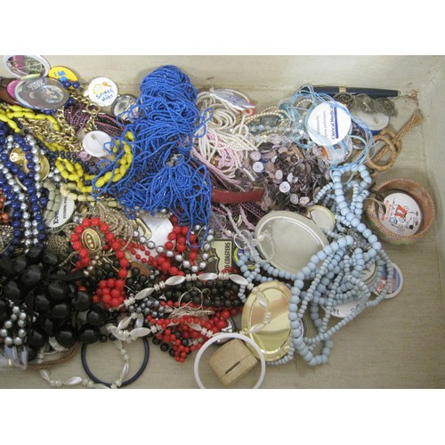 68 - Assorted costume jewellery including beaded necklaces and badges, in a vintage suitcase