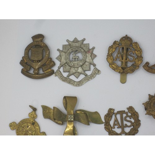 161 - A selection of military badges and other items including cross belt whistle and a bosun's whistle