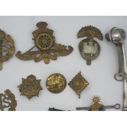 161 - A selection of military badges and other items including cross belt whistle and a bosun's whistle