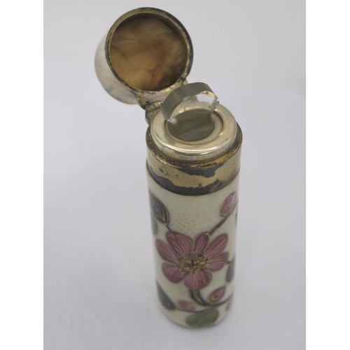 172 - A silver and yellow enamel lidded scent bottle and a floral porcelain example with white metal lid