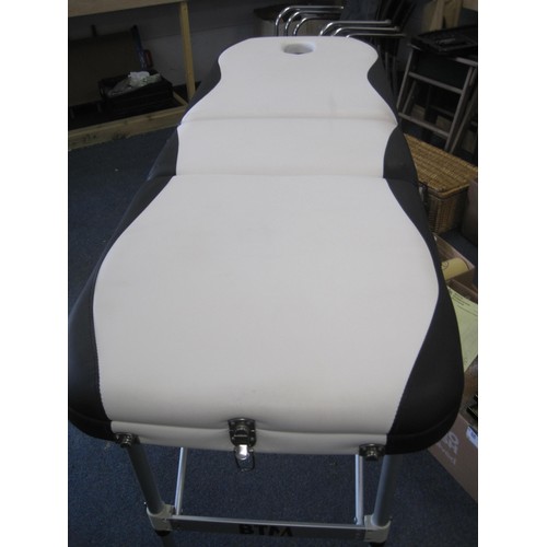 244 - A portable massage table in carry case, in good condition