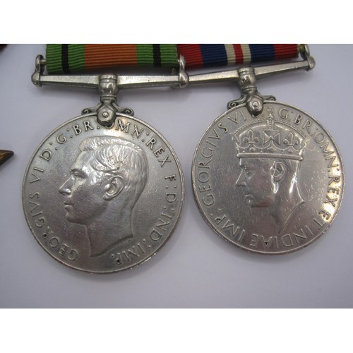 77 - A group of four World War 2 medals and ribbons (Defence Medal, 1939-1945 War Medal, The 1939-1945 St... 