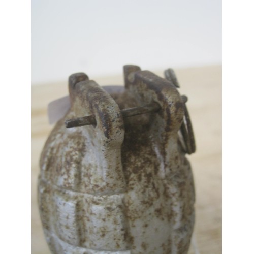 183 - An inert Mills bomb hand grenade mase into a paperweight, stamped with the letter 'K' and mounted on... 