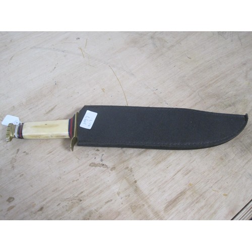 197 - A large saw back Bowie knife with bone handle in its scabbard. Blade length 32cms