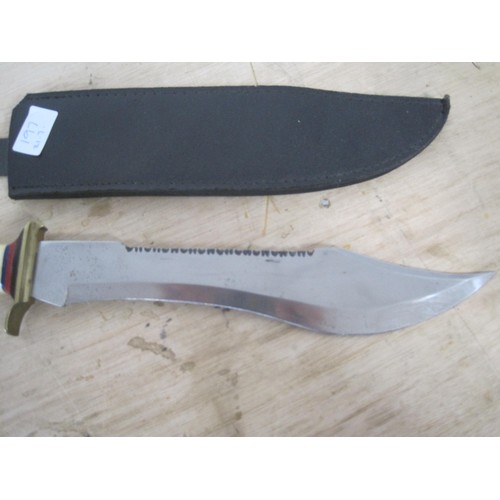 197 - A large saw back Bowie knife with bone handle in its scabbard. Blade length 32cms