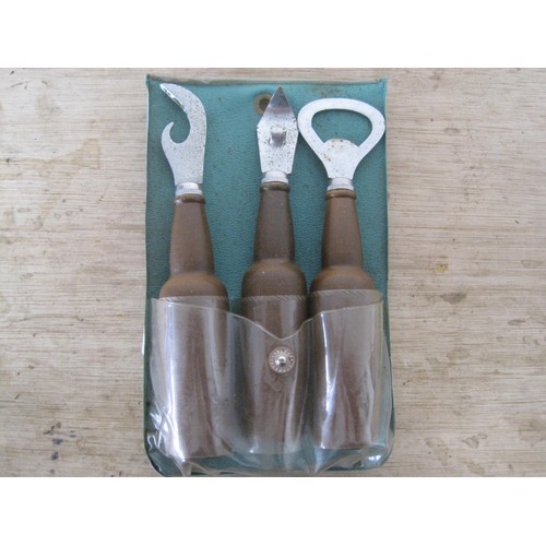 162 - A pack of three bottle opening tools with wooden handles shaped as beer bottles