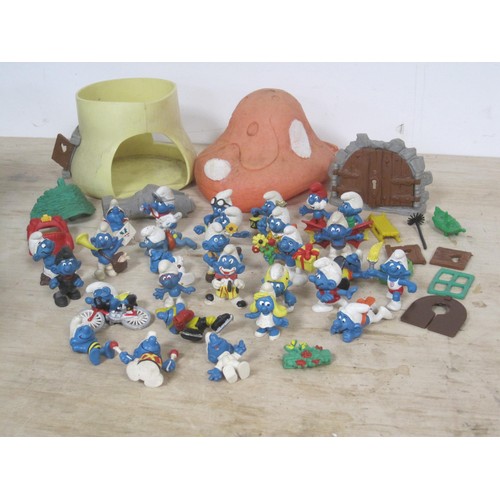 168 - The Smurfs - about twenty-eight Peyo Schleich Smurf figures, many marked W. Germany, together with a... 