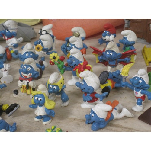 168 - The Smurfs - about twenty-eight Peyo Schleich Smurf figures, many marked W. Germany, together with a... 