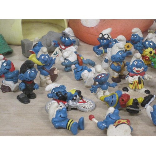 168 - The Smurfs - about twenty-eight Peyo Schleich Smurf figures, many marked W. Germany, together with a... 