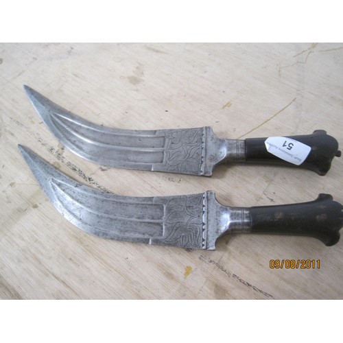 51 - A pair of Arabian or Middle Eastern daggers, decorated blades, both in good order, no scabbards