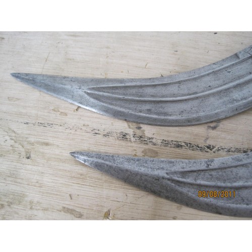 51 - A pair of Arabian or Middle Eastern daggers, decorated blades, both in good order, no scabbards