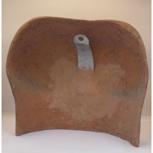 33 - A terracotta wall-mounting plaque modelled as a woman's chest. Impressed signature Daniel-Chapman. A... 