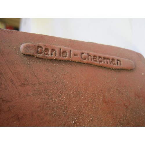 33 - A terracotta wall-mounting plaque modelled as a woman's chest. Impressed signature Daniel-Chapman. A... 