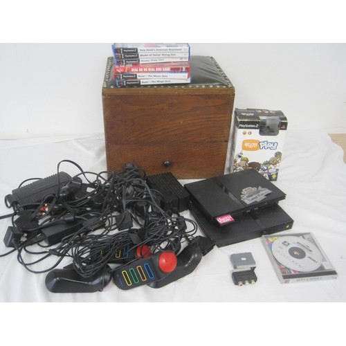 60 - A wooden box containing a pair of PS2 slim consoles, controllers, eye toy a power brick and an assor... 