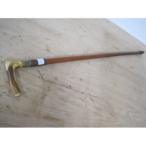 60 - A sword stick with stag horn handle. Blade length 13cms with an overall length of 84cms.