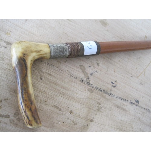 60 - A sword stick with stag horn handle. Blade length 13cms with an overall length of 84cms.