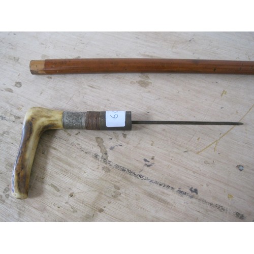 60 - A sword stick with stag horn handle. Blade length 13cms with an overall length of 84cms.