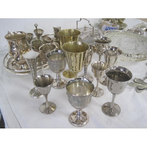 19 - An assortment of electroplated dining and table ware, including trays, goblets, egg cruets, cutlery,... 